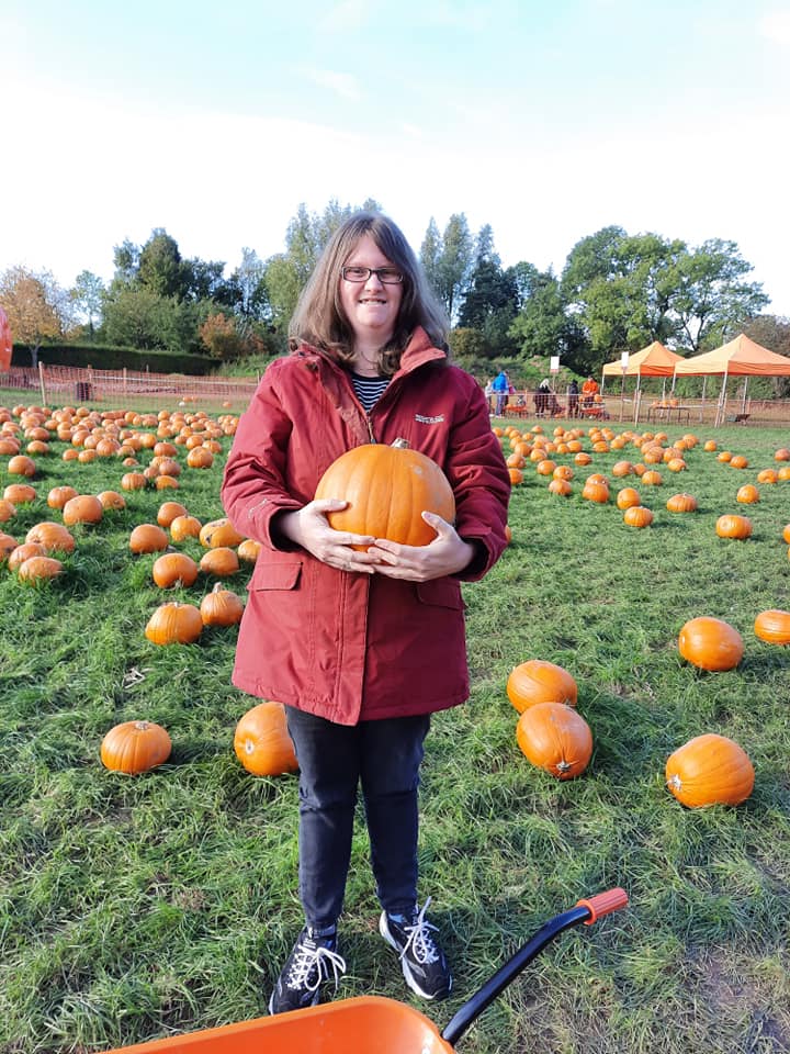 Autistic lady holding pumpkin